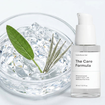 The Care Formula Hydra Boost Gel skincare serum bottle with a petri glass filled with crystal-clear gel texture and herbs on a light background
