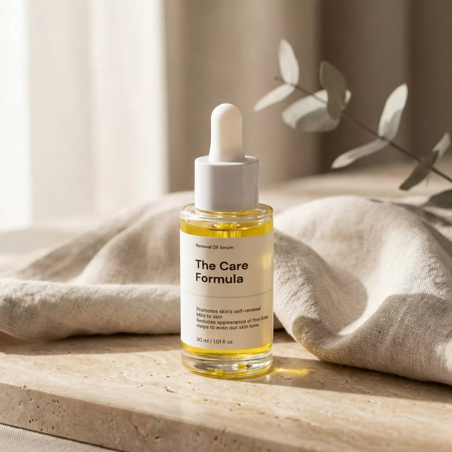 The Care Formula Renewal Oil Serum lifestyle image with eucalyptus on neutral stone surface