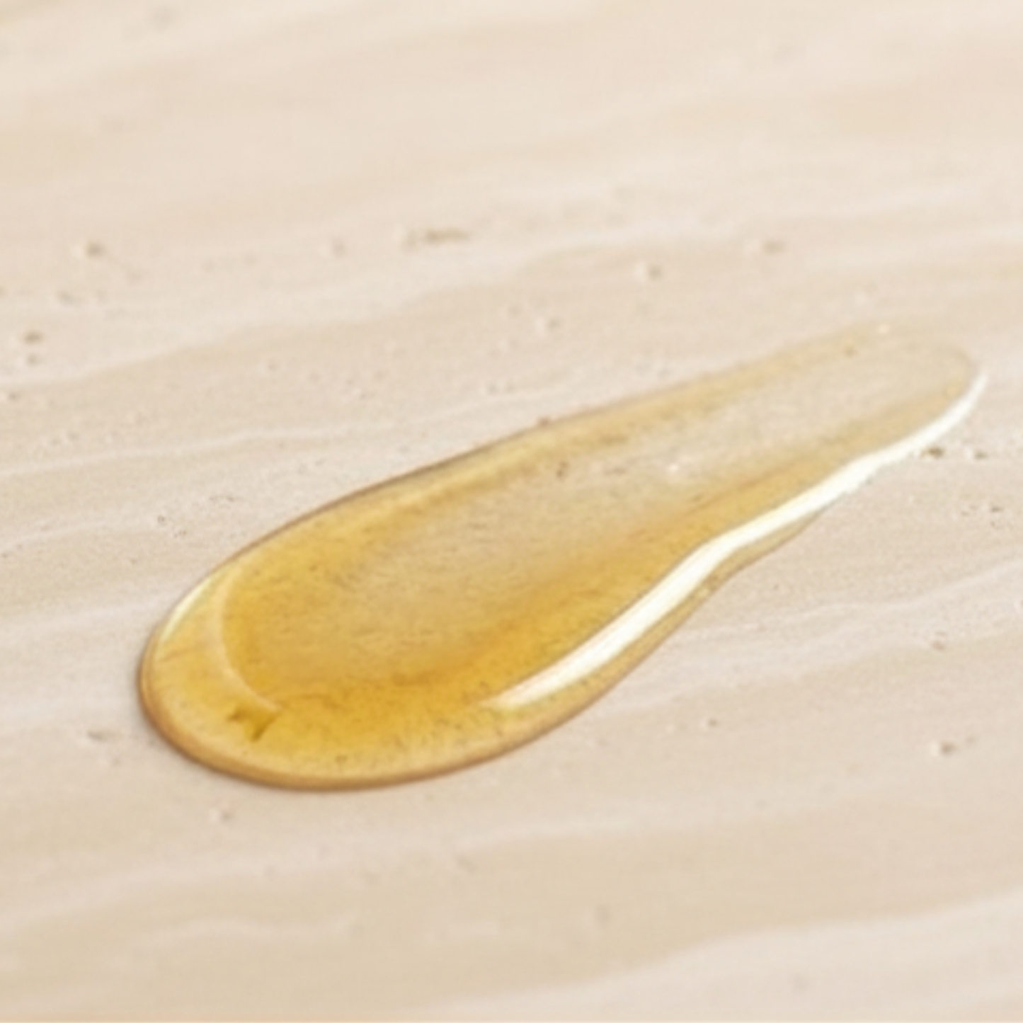 The Care Formula Replenishing Glow Oil golden oil texture close-up