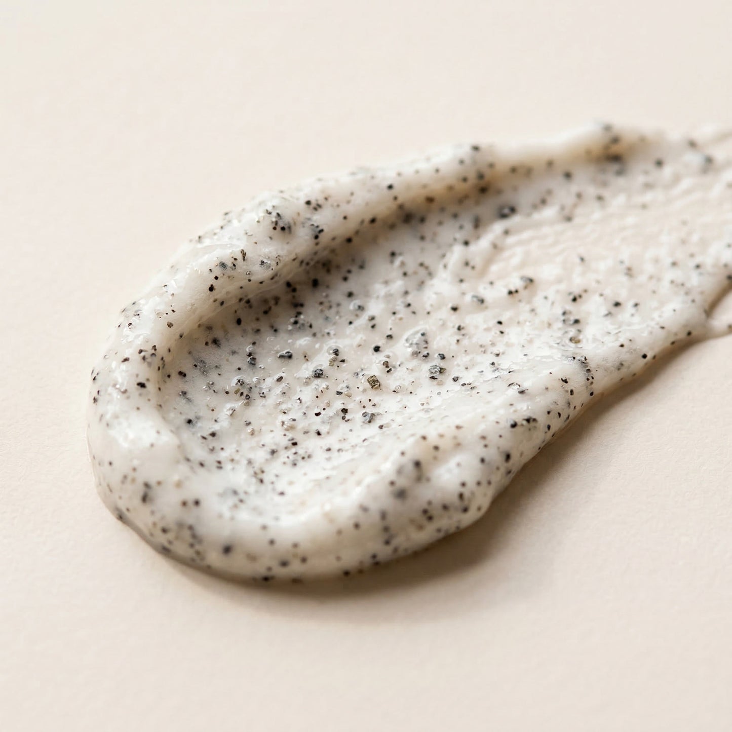 The Care Formula Volcanic Renewal Face and Body Scrub grain scrub texture close-up